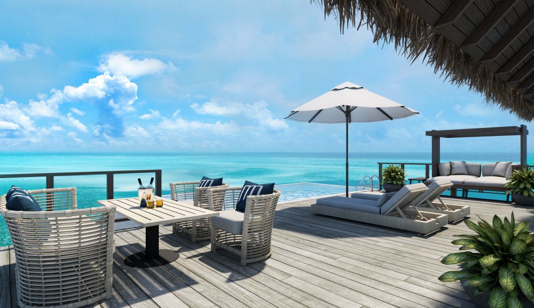 Private over water villa deck with infinity pool and modern outdoor furniture looking out over the turquoise ocean in the Maldives