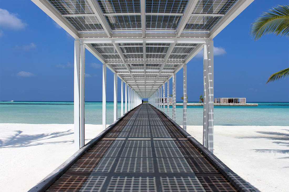 sustainable over water resort walkway with solar panels in the Maldives