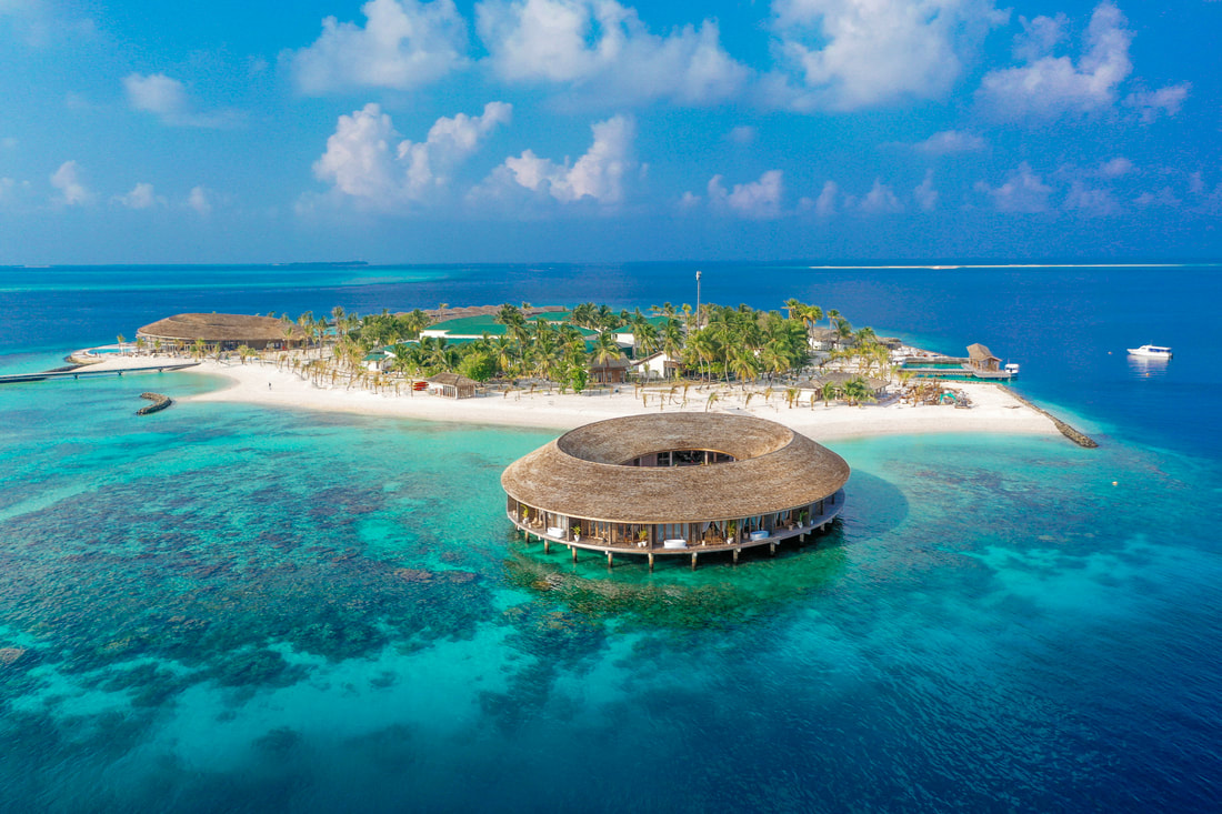Luxury spa island resort in the Maldives with stilted over water buildings. 