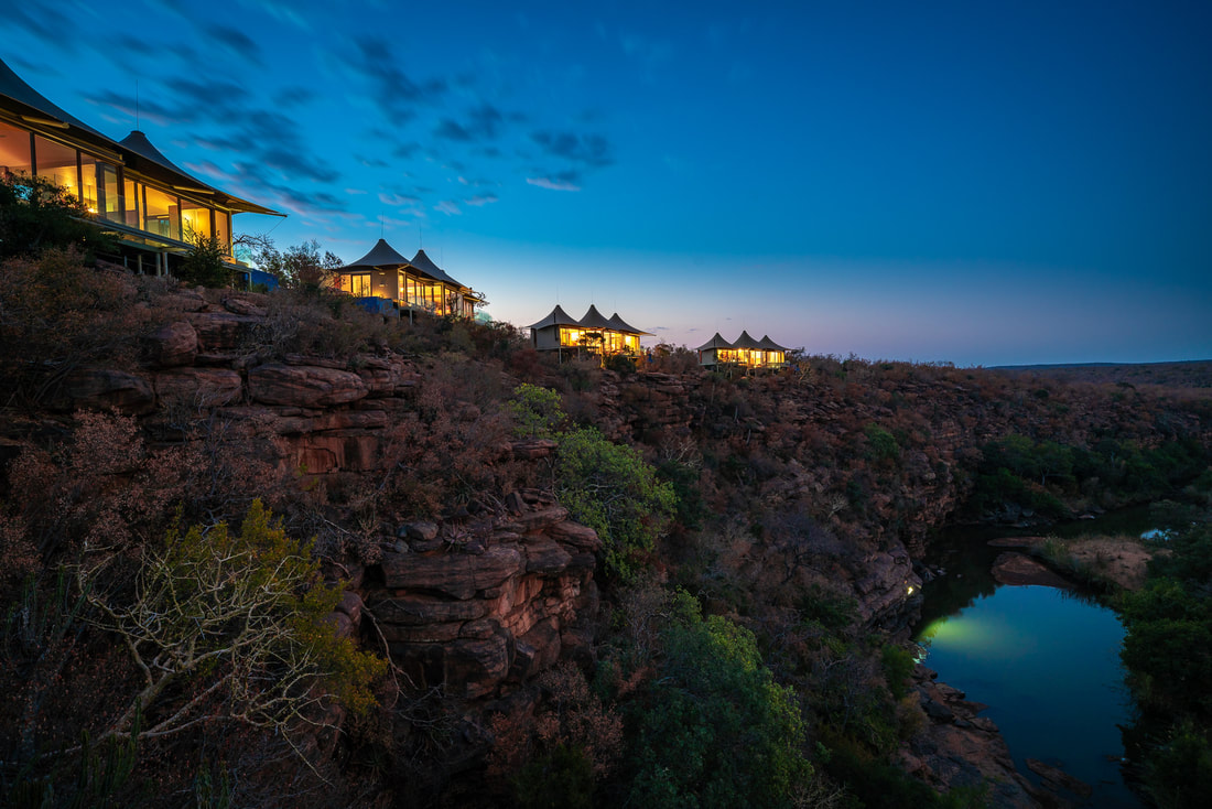 Safari sustainable villas perched on a cliff over a wildlife preserve at night