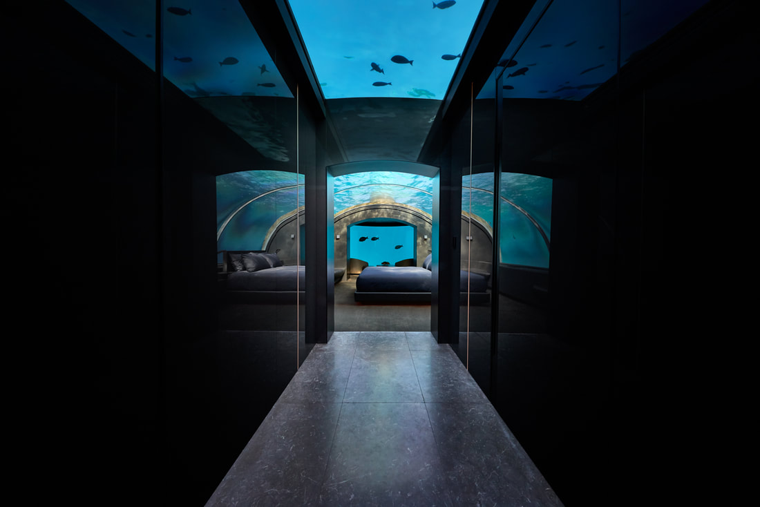 Corridor with an aquarium skylight leading to the bedroom of the underwater villa.