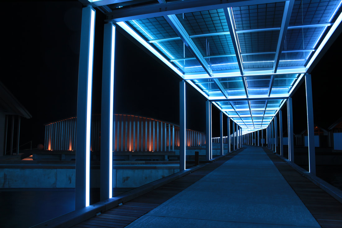 eco friendly solar panel walkway from the beach to the coral reefs at night